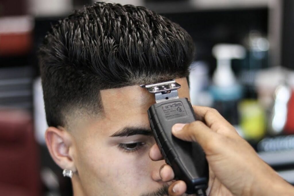 A barber using the best hairline clipper to create neat trims along the natural hairline